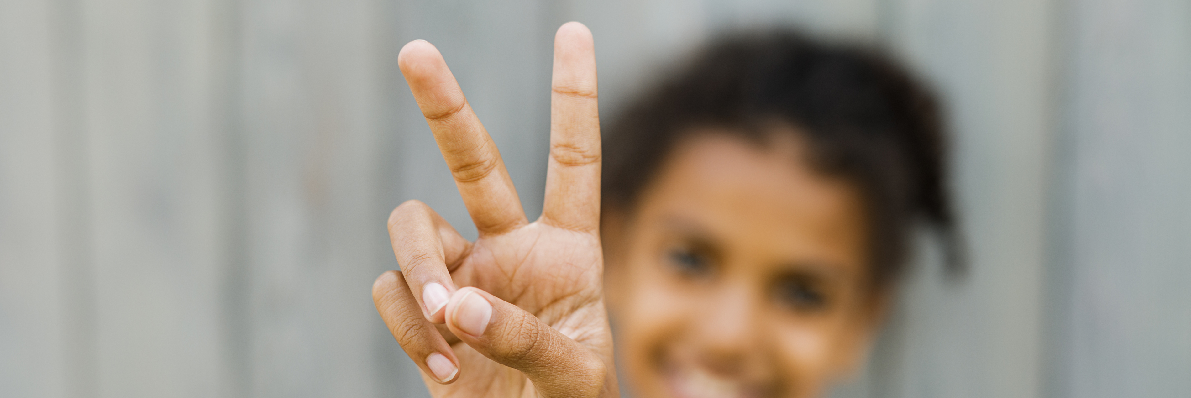 photo of woman giving the peace sign