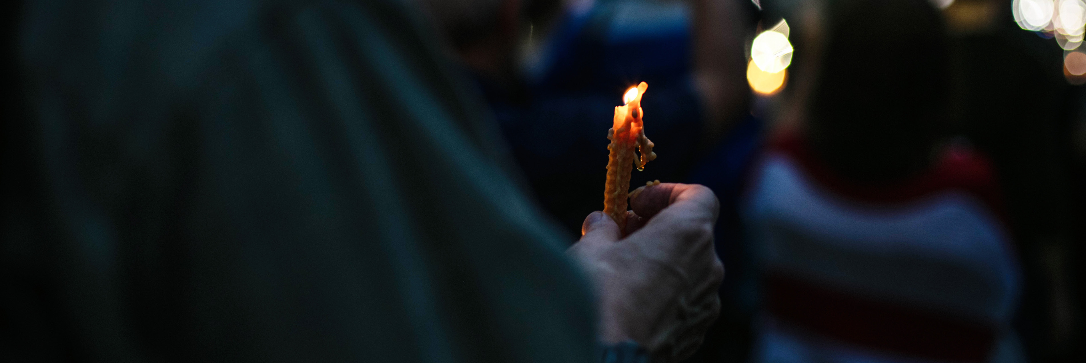 photo of person holding a candle