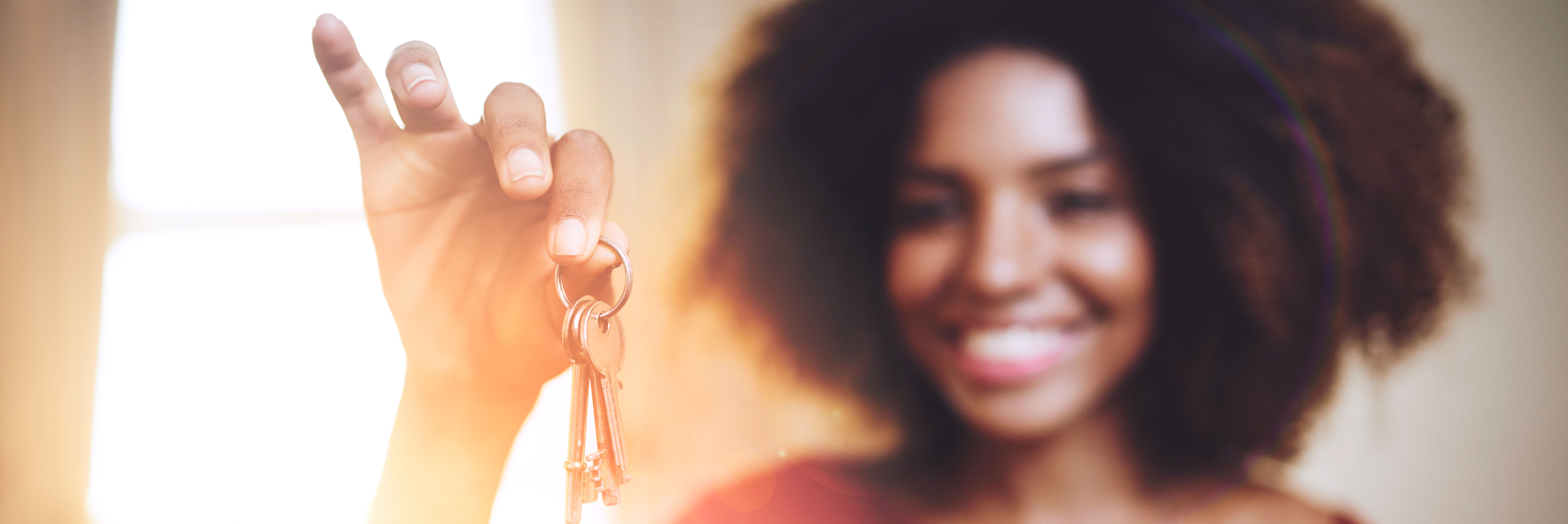 Smiling woman holding keys