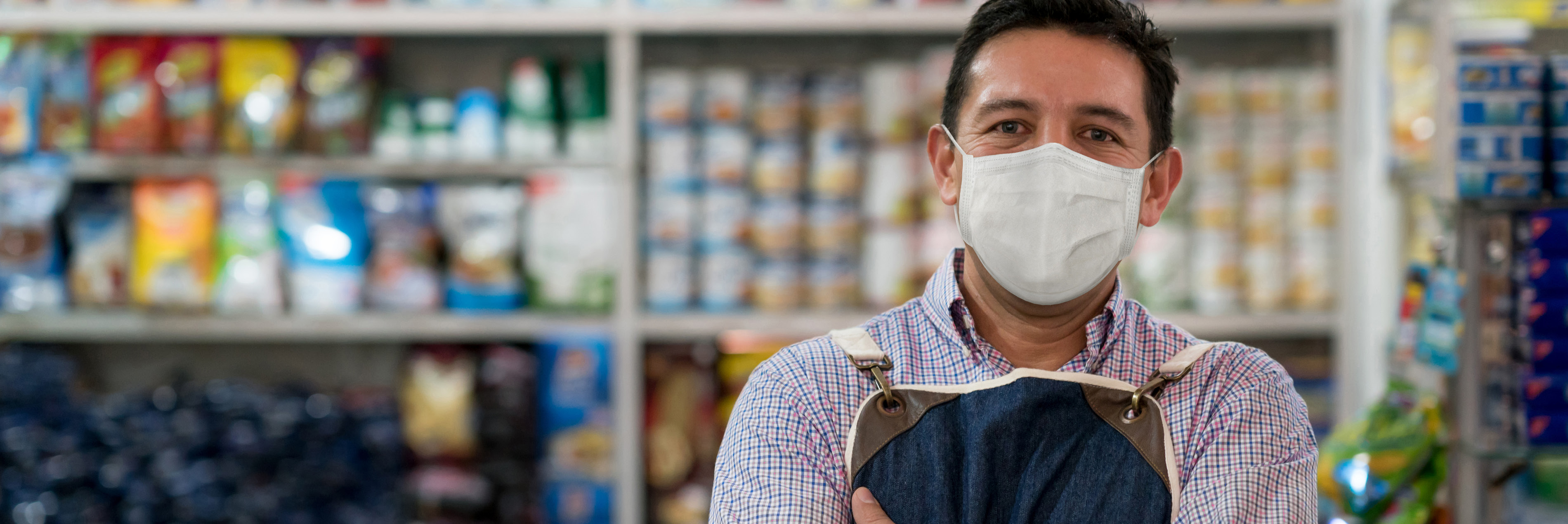 Man with face mask working at store