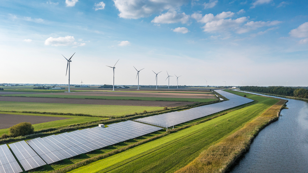 Solar panels and wind turbines in a field