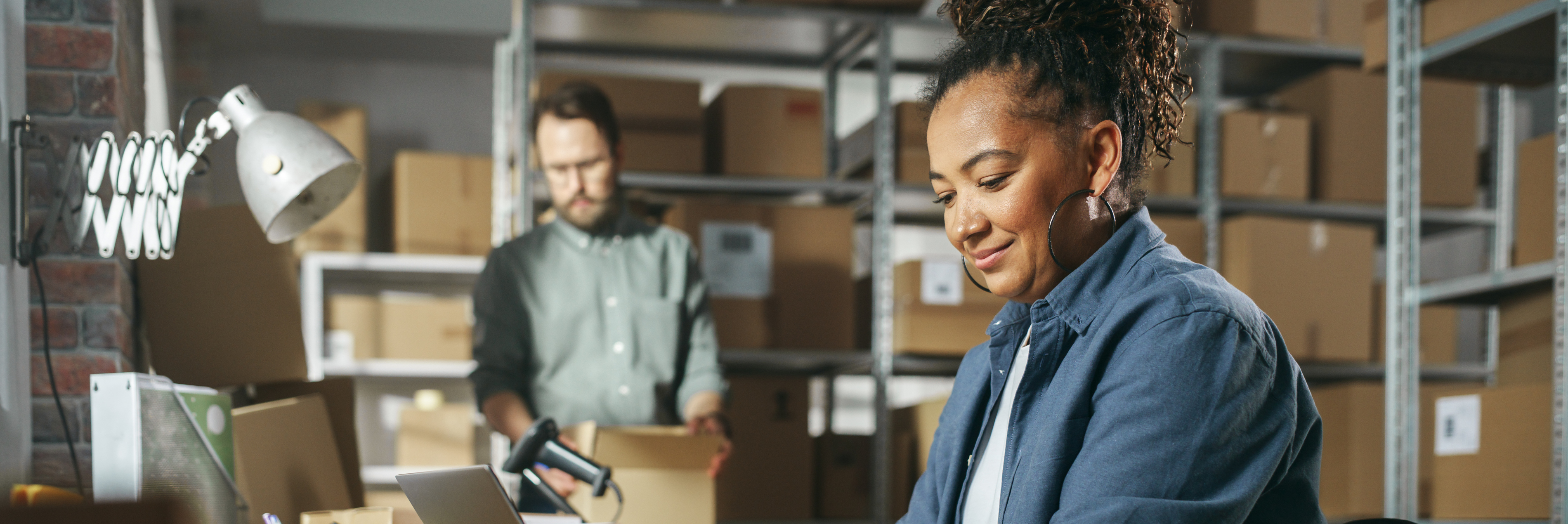 Man and woman boxing items at a business