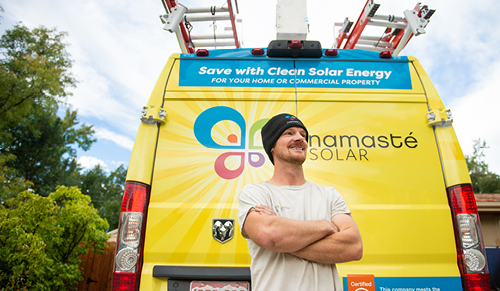 Namaste Solar employee in front of truck