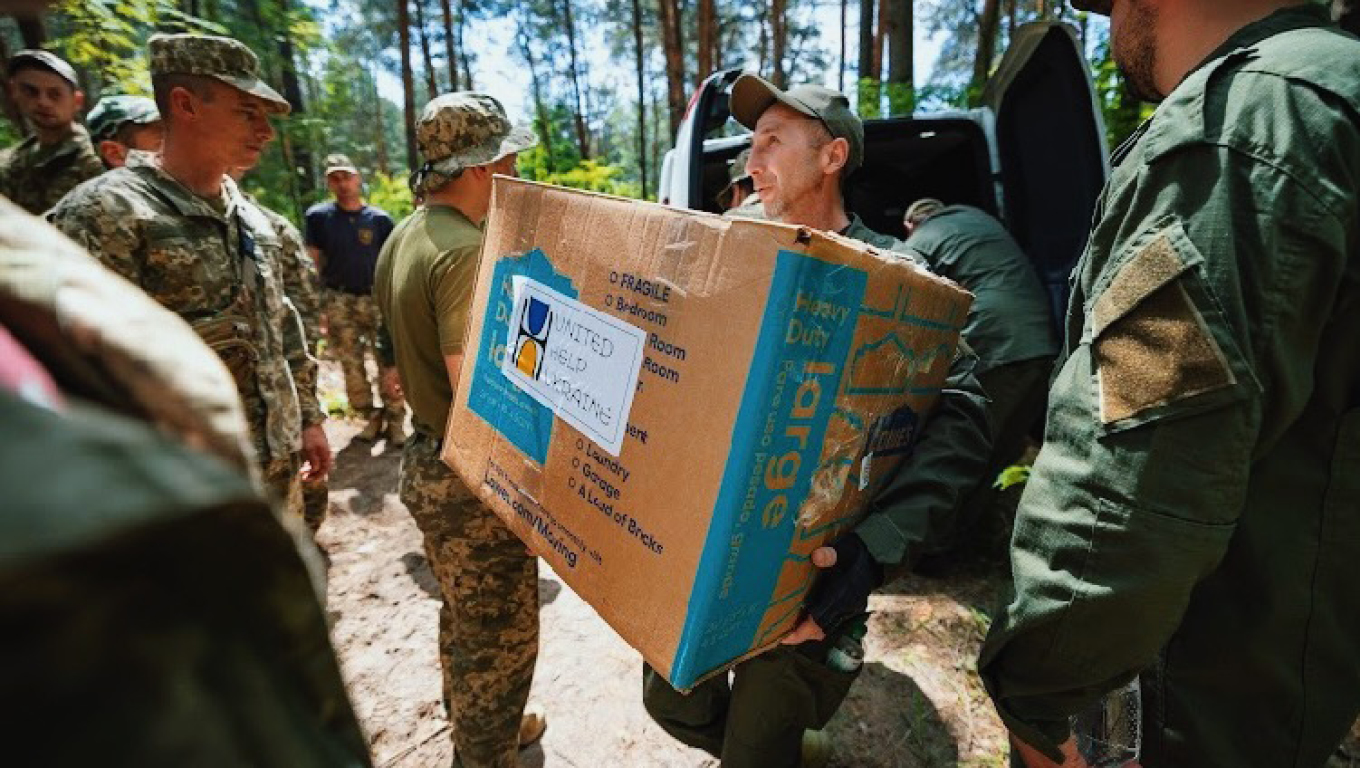 Person carrying United Help Ukraine box