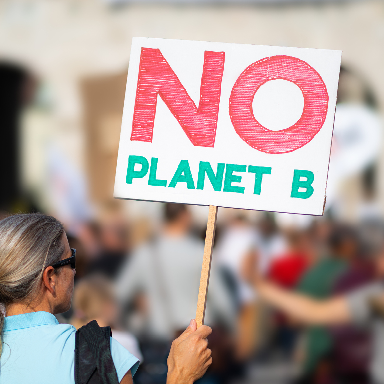 Woman holding a new planet B sign