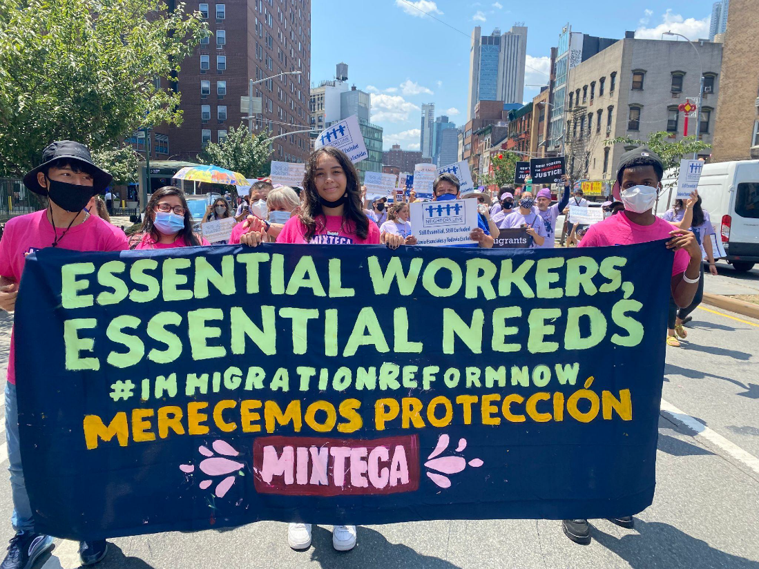 People holding a Mixteca banner at a parade