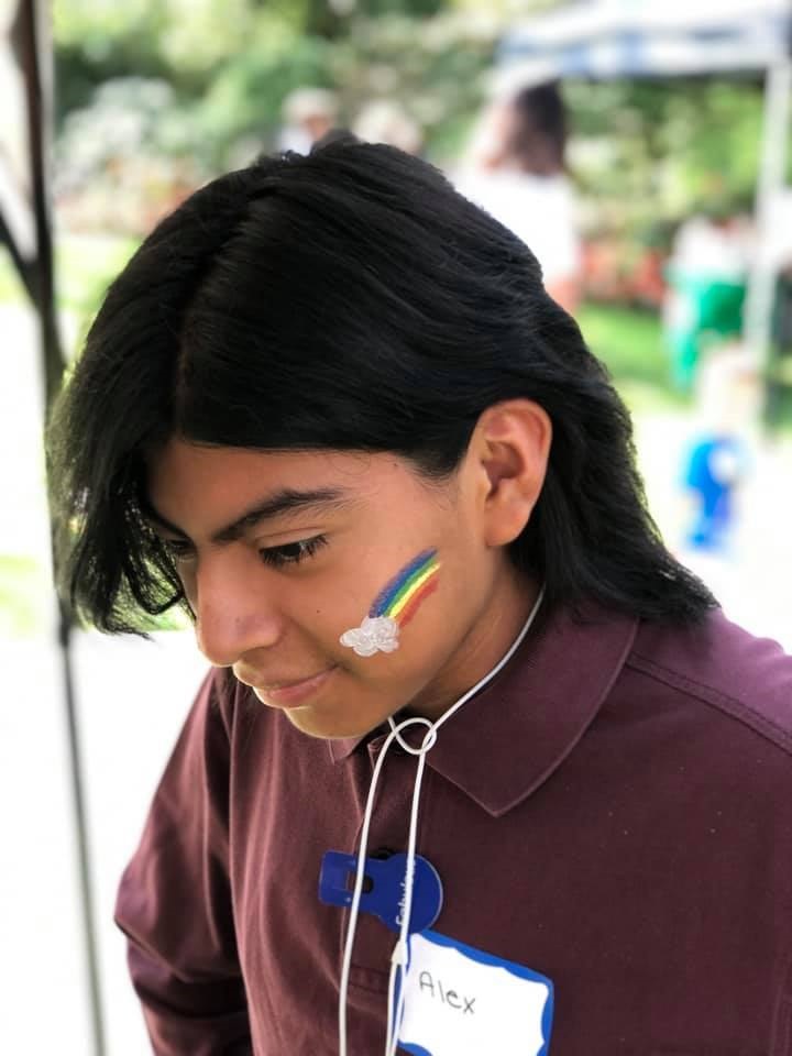 Kid with a rainbow painted on face